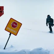 The tourist enters the forbidden dangerous zone of the avalanche